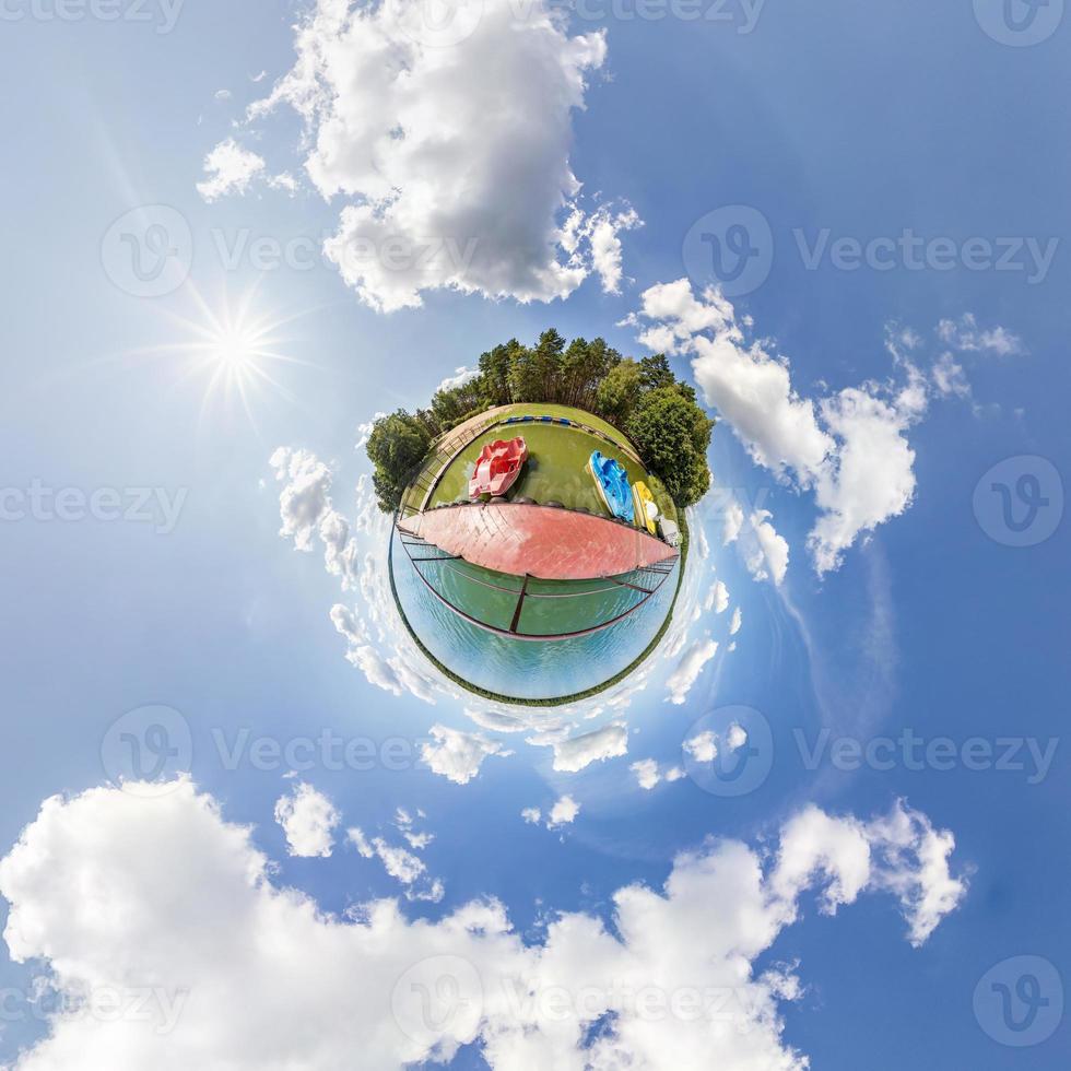 Little planet transformation of spherical panorama 360 degrees. Spherical abstract aerial view in field with awesome beautiful clouds. Curvature of space. photo