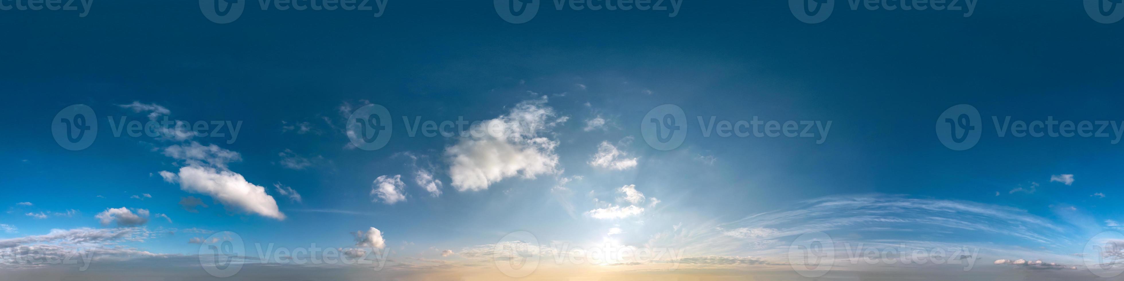 blue sky with clouds with evening sun. Seamless hdri panorama 360 degrees angle view with zenith for use in 3d graphics or game development as sky dome or edit drone shot photo