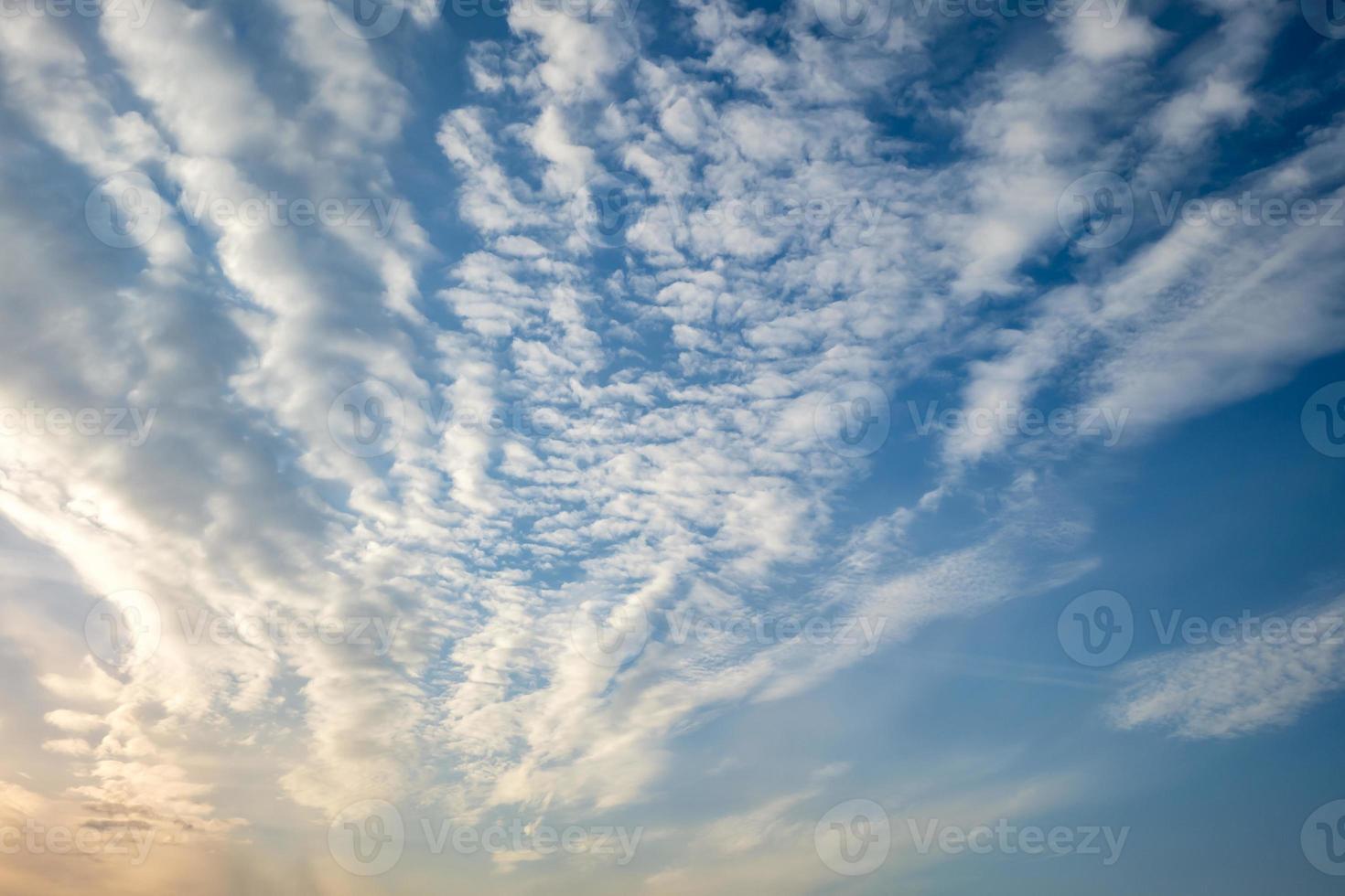 Blue sky background with tiny stratus cirrus striped clouds. Clearing day and Good windy weather photo