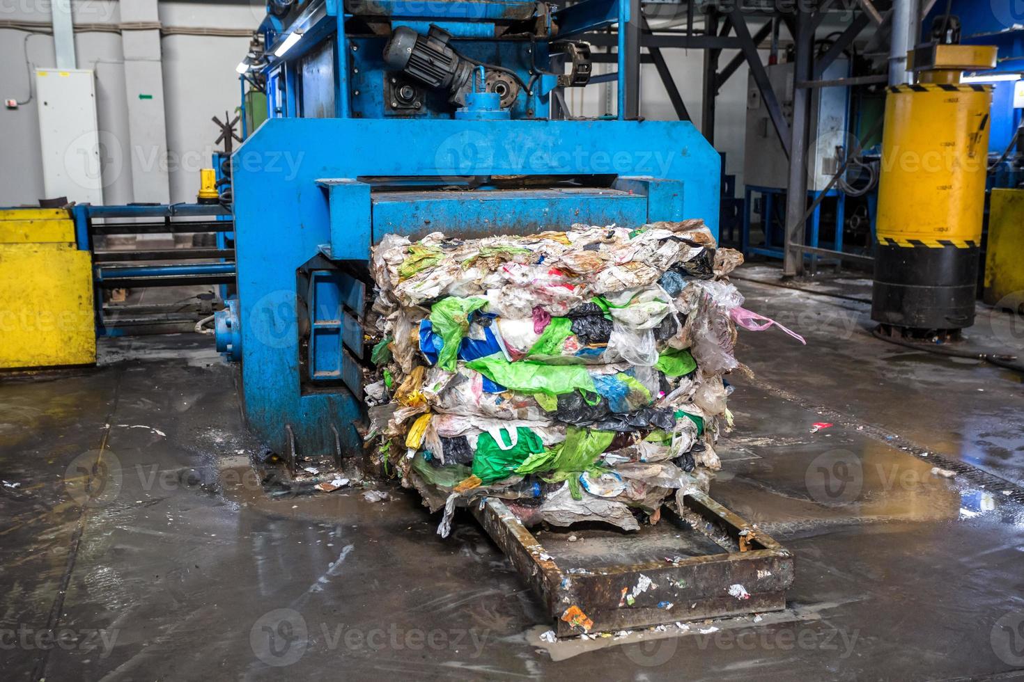 Equipment for pressing debris sorting material to be processed in modern waste recycling plant. garbage press on modern waste recycling processing plant. Business for sorting and processing of waste. photo