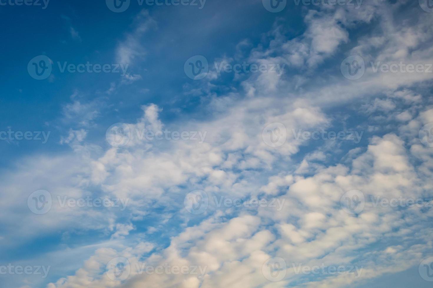Blue sky background with tiny stratus cirrus striped clouds. Clearing day and Good windy weather photo