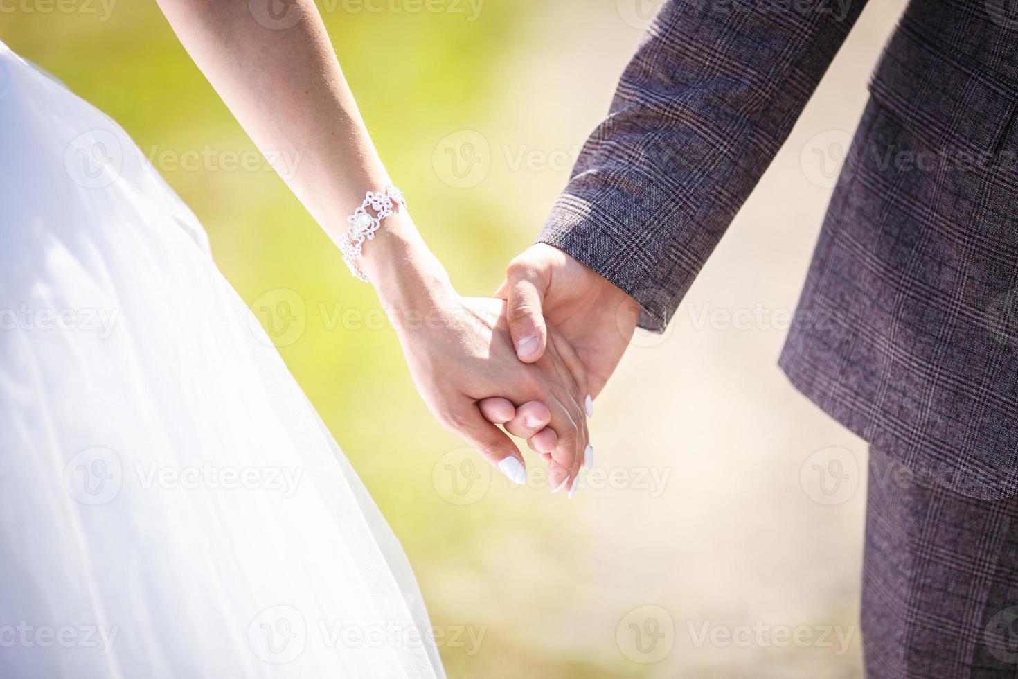 romantic couple holding hands. Lovers or newlywed married young couple in romance. wedding theme photo