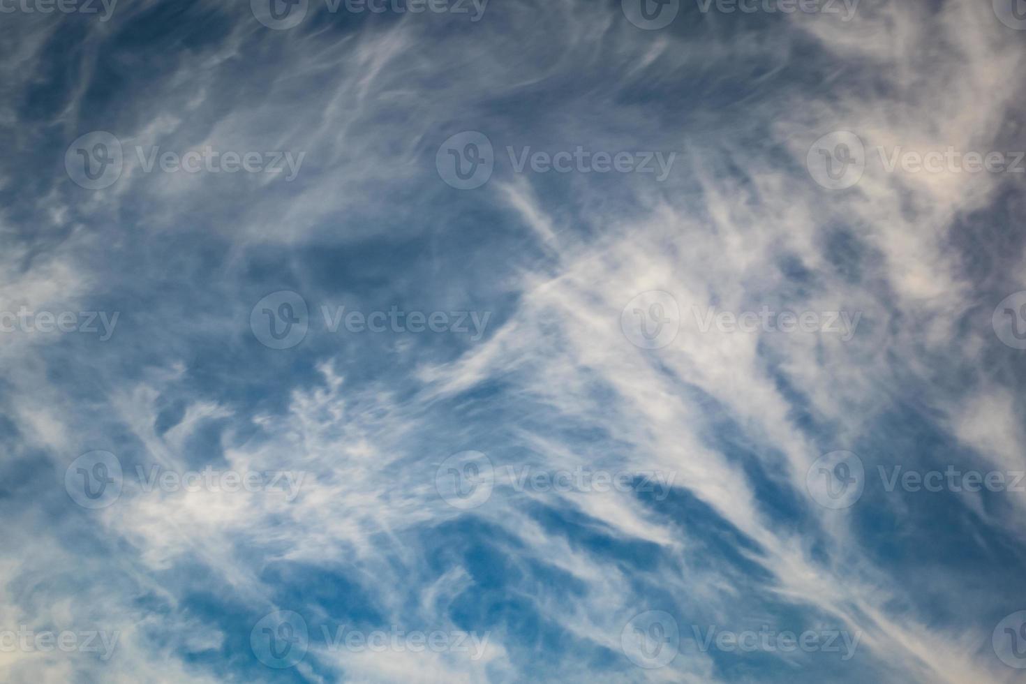 Blue sky background with tiny stratus cirrus striped clouds. Clearing day and Good windy weather photo
