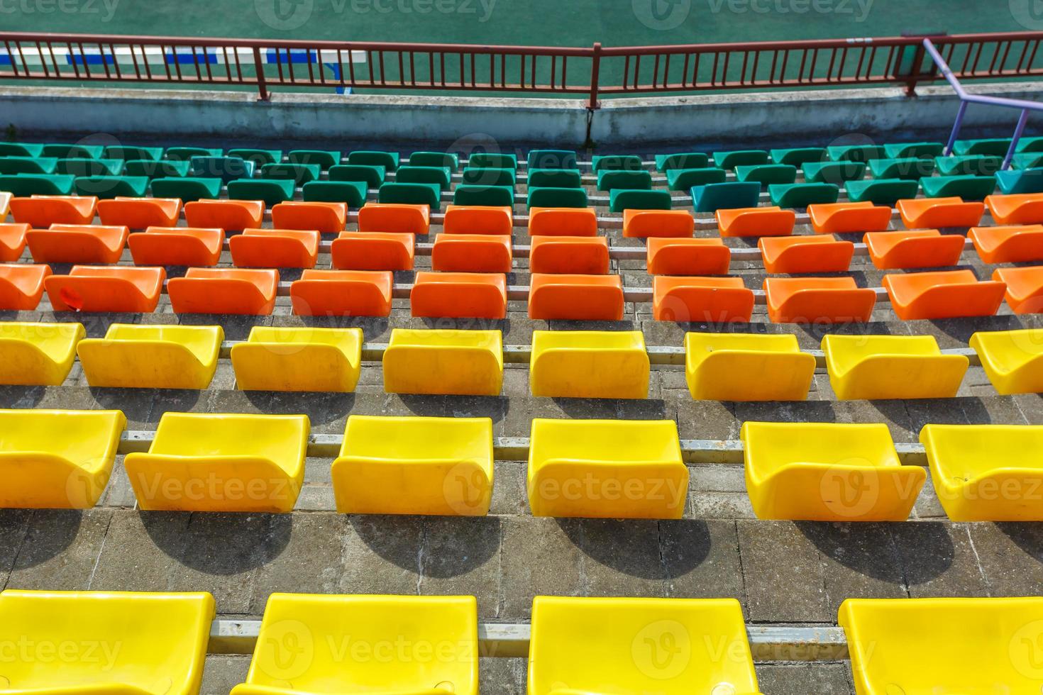 multi-colored rows of plastic seats in the stadium photo