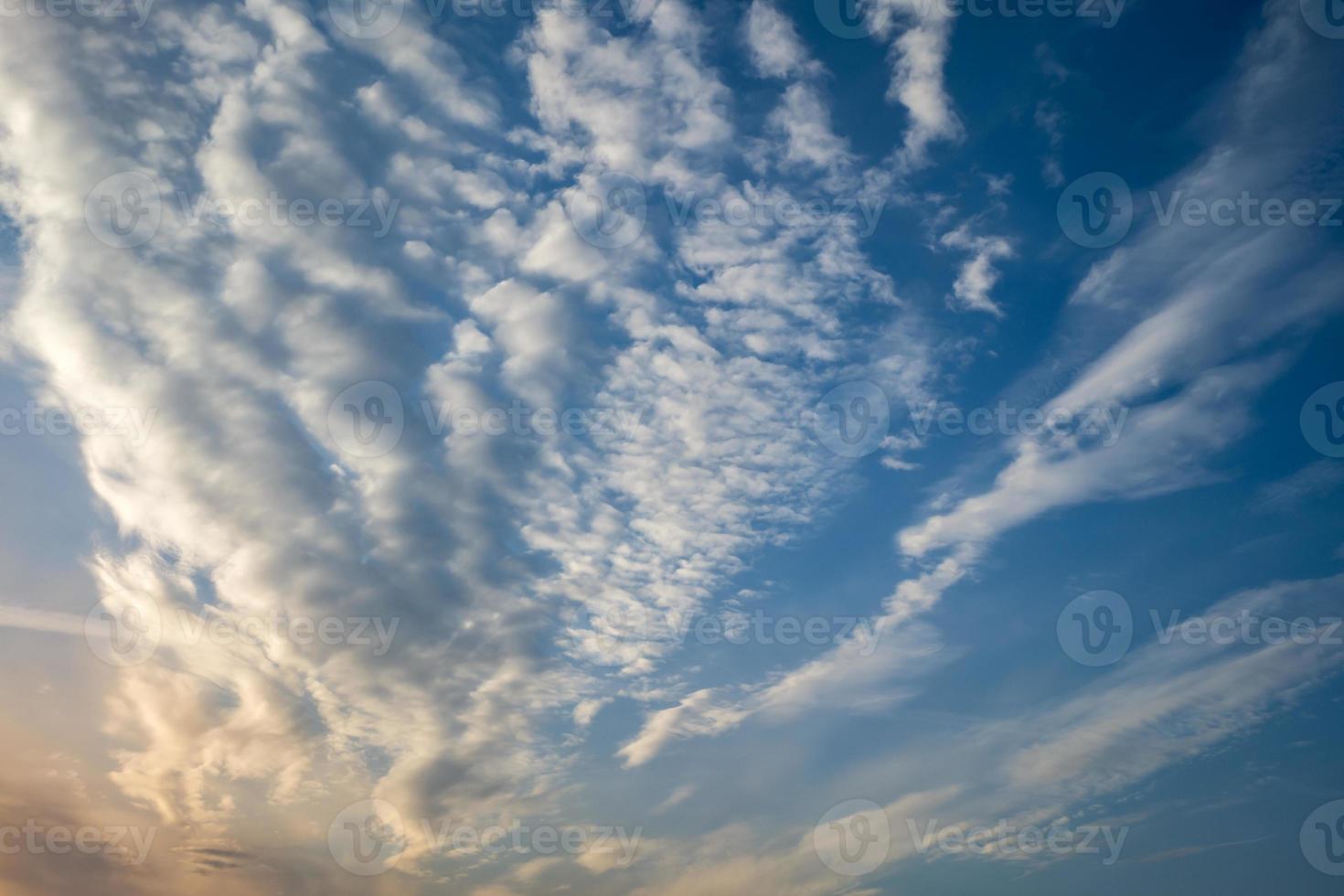 Blue sky background with tiny stratus cirrus striped clouds. Clearing day and Good windy weather photo