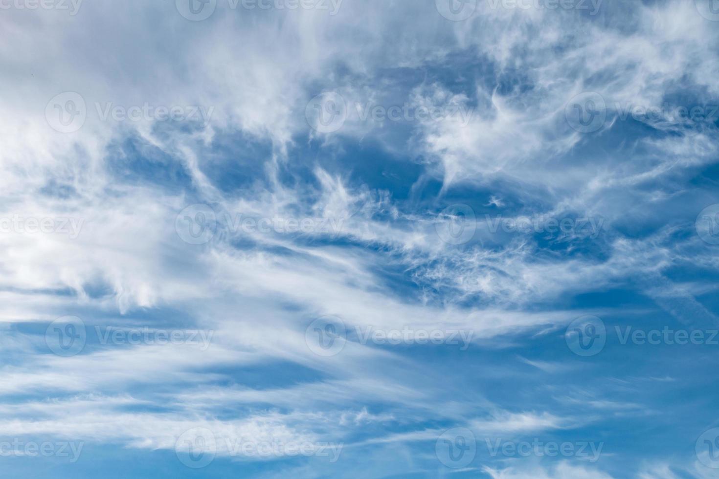 Blue sky background with tiny stratus cirrus striped clouds. Clearing day and Good windy weather photo
