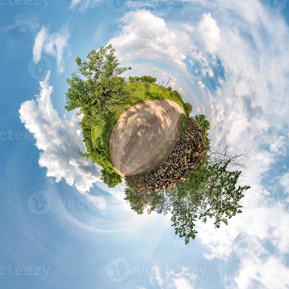 Little planet transformation of spherical panorama 360 degrees. Spherical abstract aerial view in field with awesome beautiful clouds. Curvature of space. photo