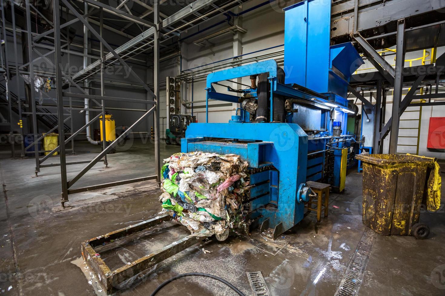 Equipment for pressing debris sorting material to be processed in modern waste recycling plant. garbage press on modern waste recycling processing plant. Business for sorting and processing of waste. photo