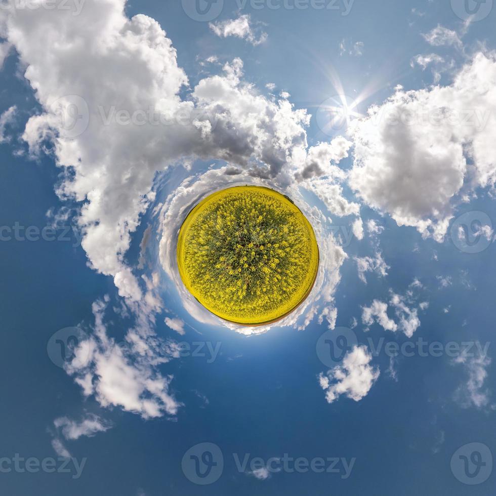 Little planet transformation of spherical panorama 360 degrees. Spherical abstract aerial view in field with awesome beautiful clouds. Curvature of space. photo