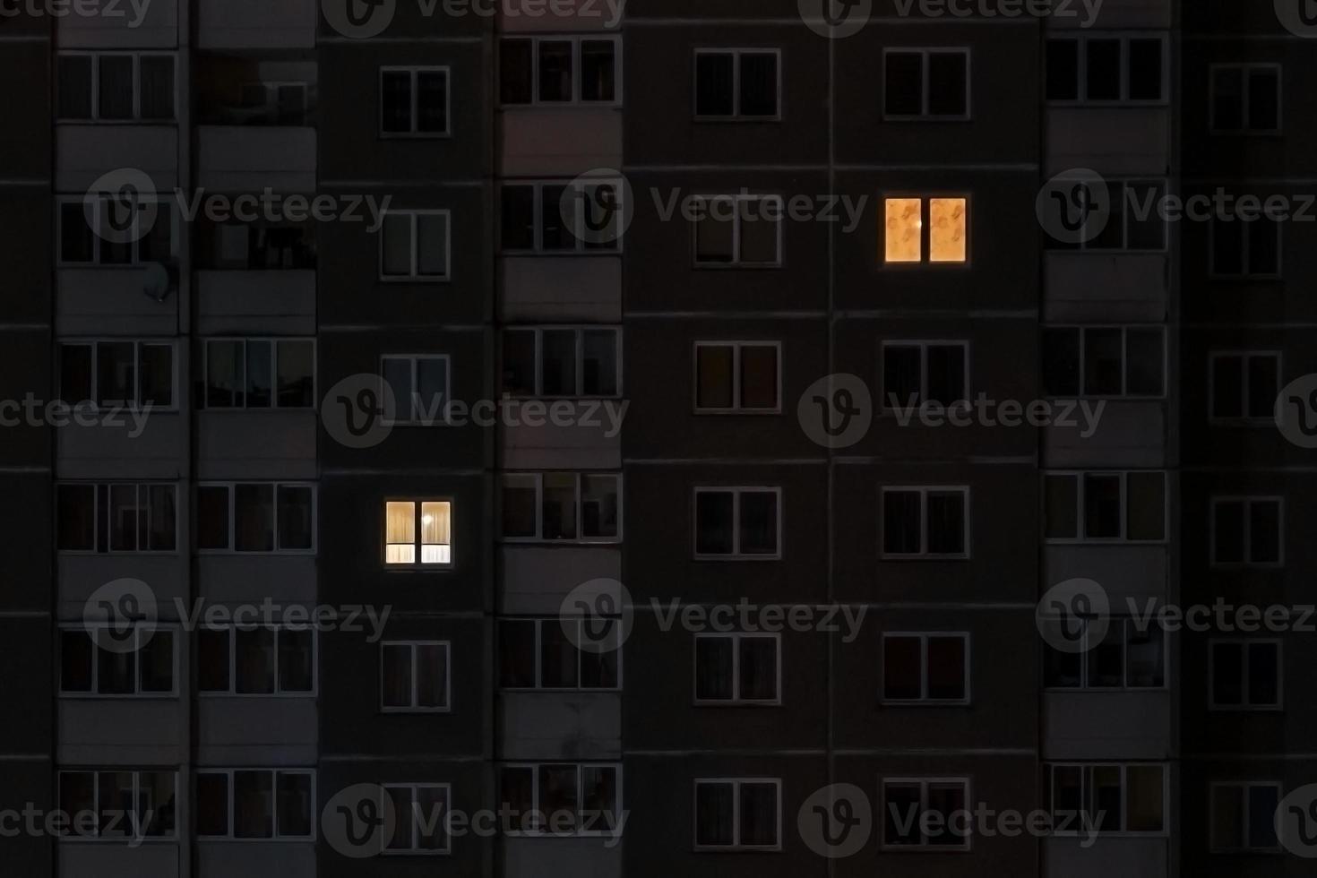 Flat night panorama of light in windows of multistory buildings. life in big city. concept for a couple in love on isolation photo