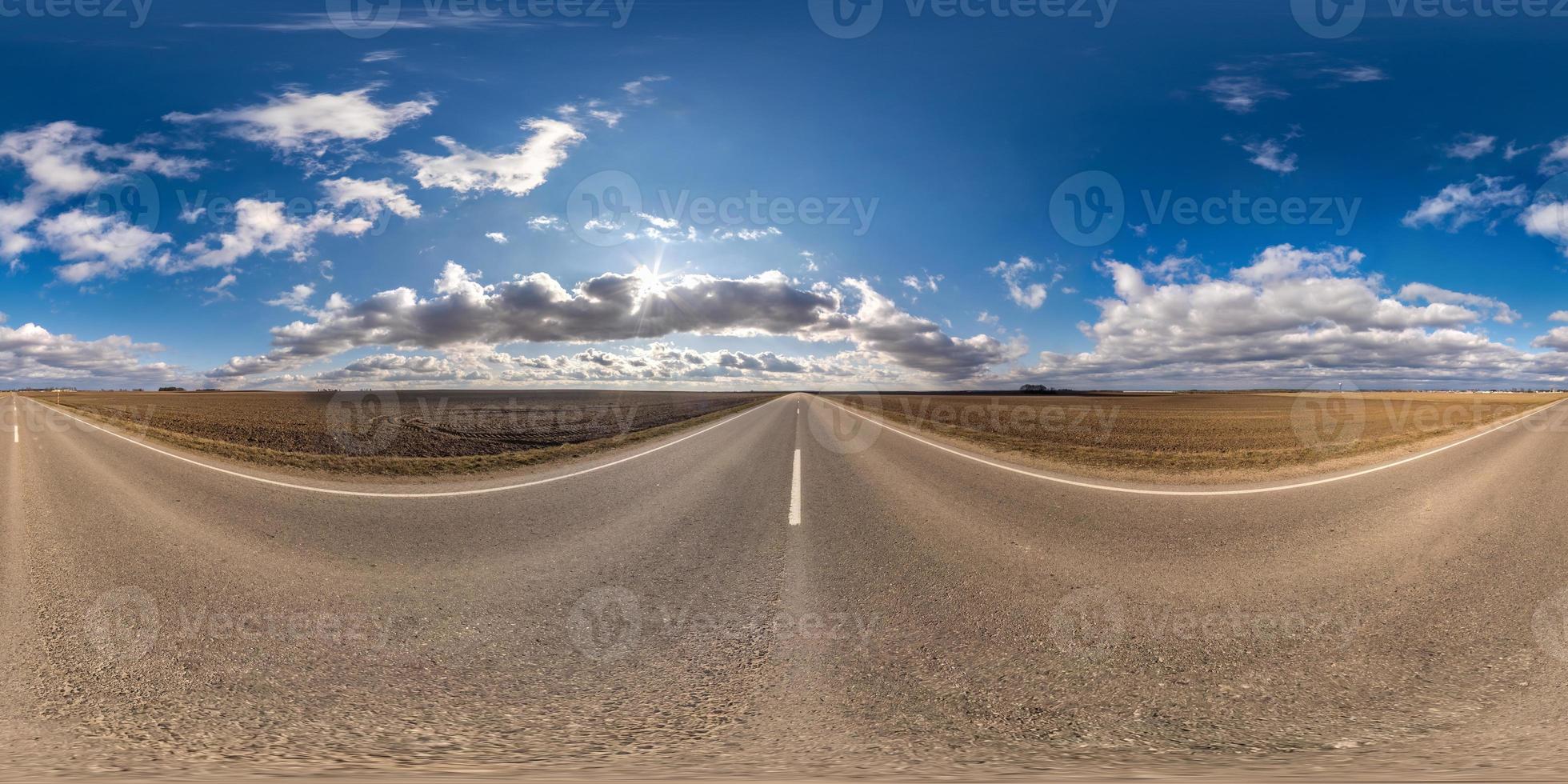 Full spherical seamless panorama 360 degrees angle view on no traffic asphalt road among fields in sunny day with cloudy sky. 360 panorama in equirectangular projection, VR AR content photo