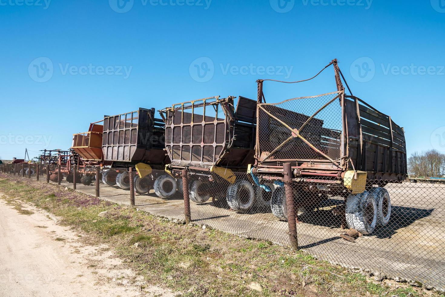 Parking agricultural machinery and harvest. rows of plows, cultivators, bodies photo