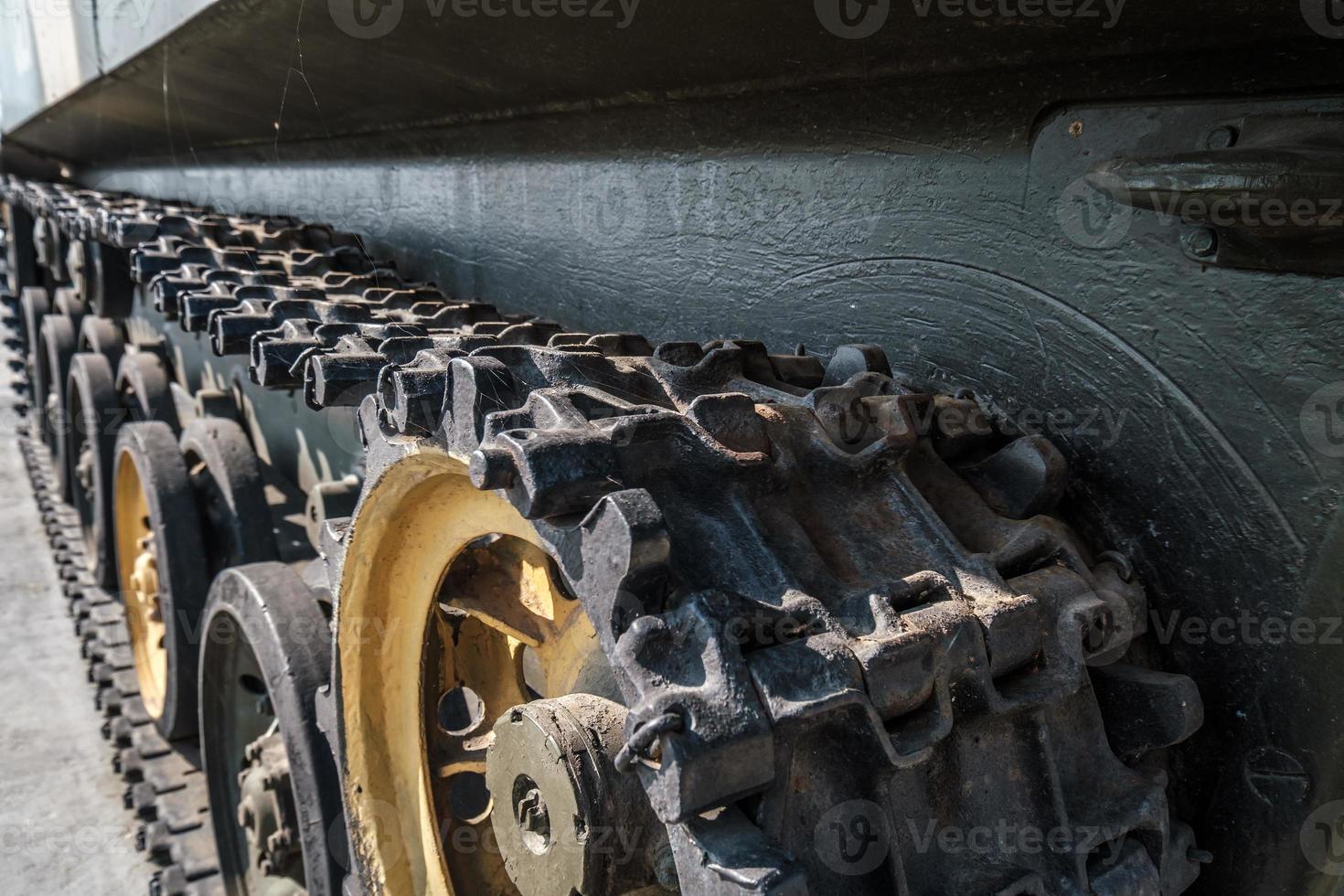 tracks and wheels of tank, armored vehicles on the street in green khaki color photo