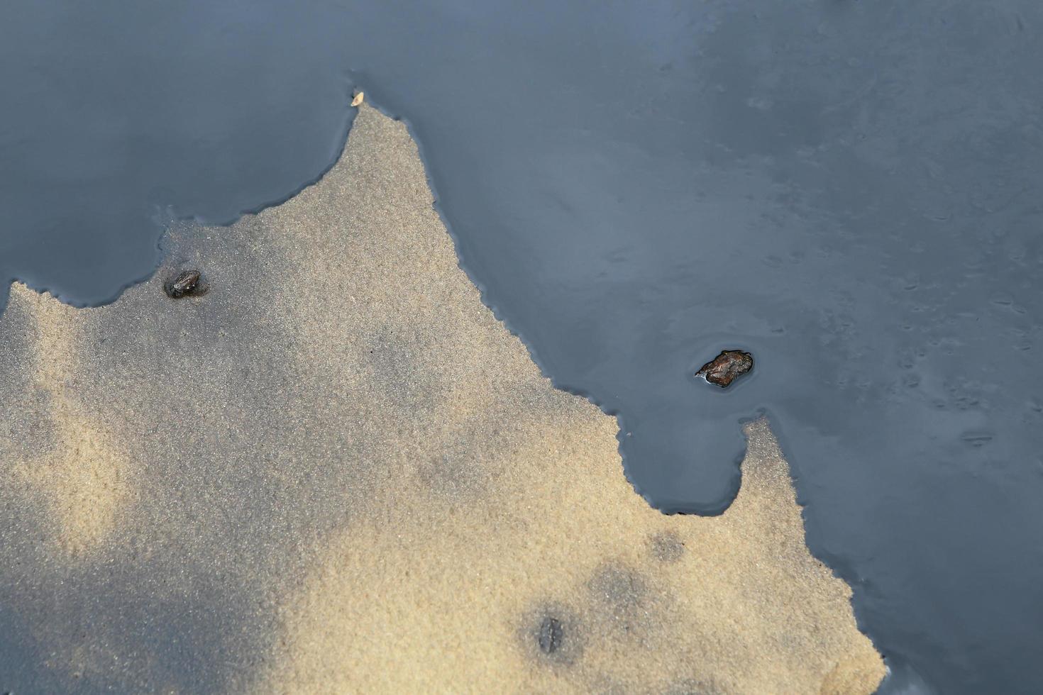 Gulf oil spill is shown on a beach photo