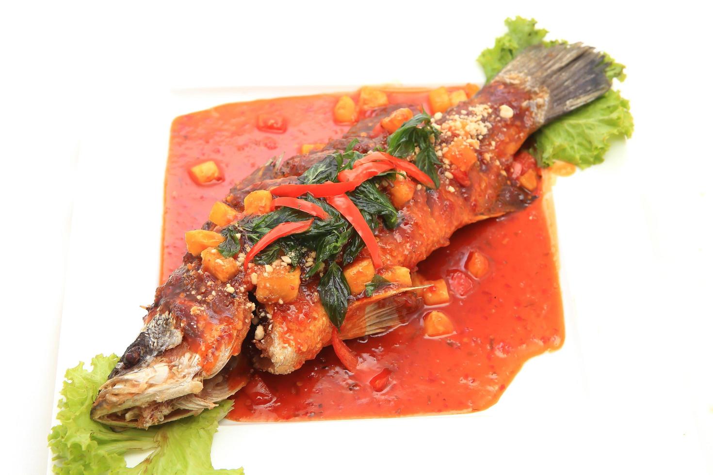 Fried snapper with chili sauce on the plate photo