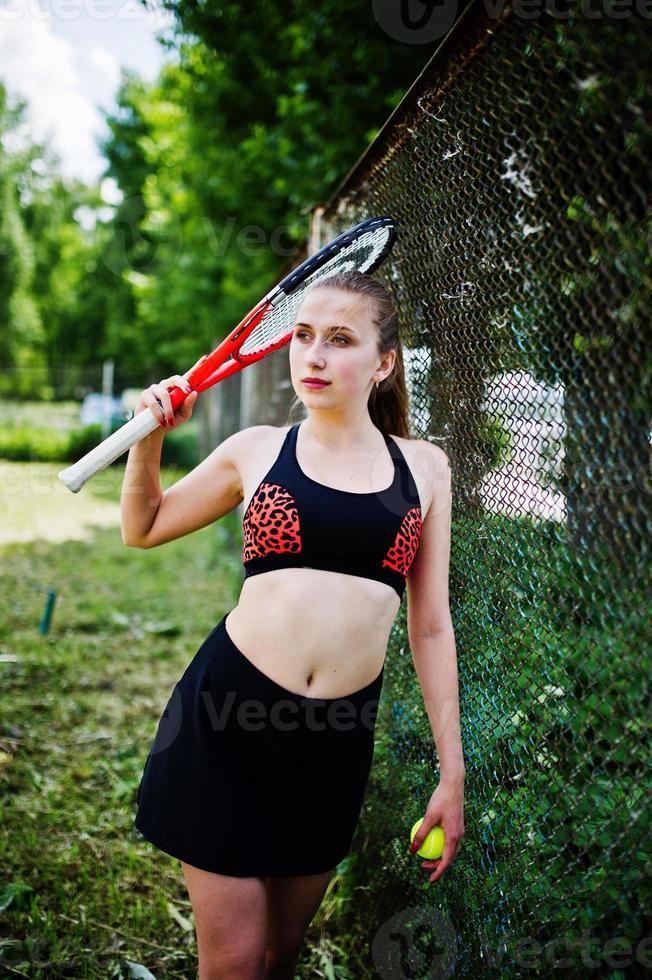 Beautiful sport woman tennis player with racket in sportswear costume. photo