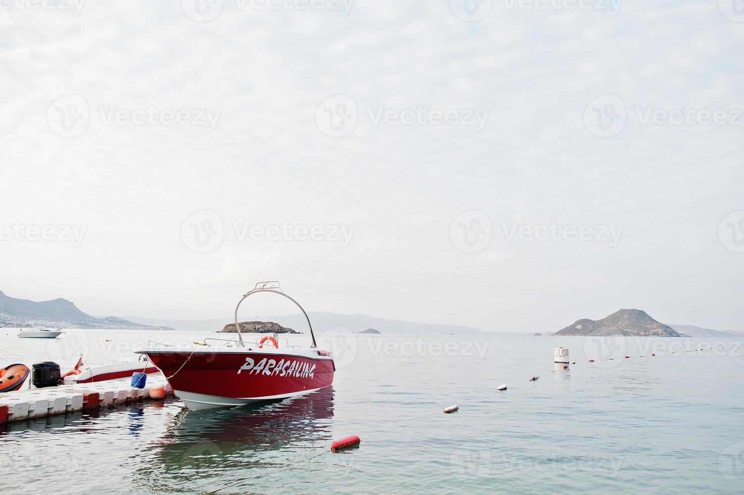 Red parasailing boat on a calm blue sea of Bodrum, Turkey. photo