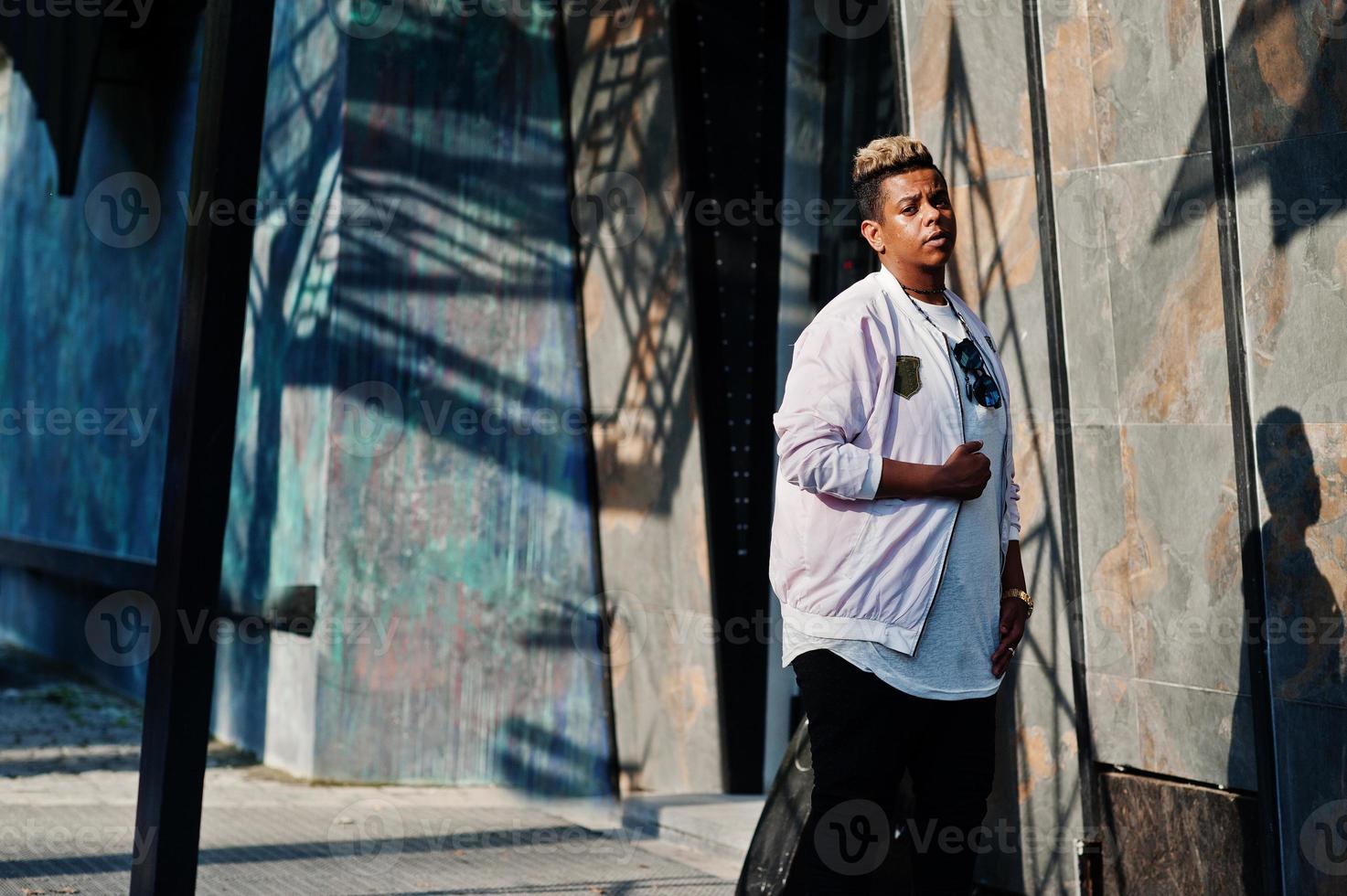 Stylish hipster arab man guy posed outdoor in street. Style rap singer. photo