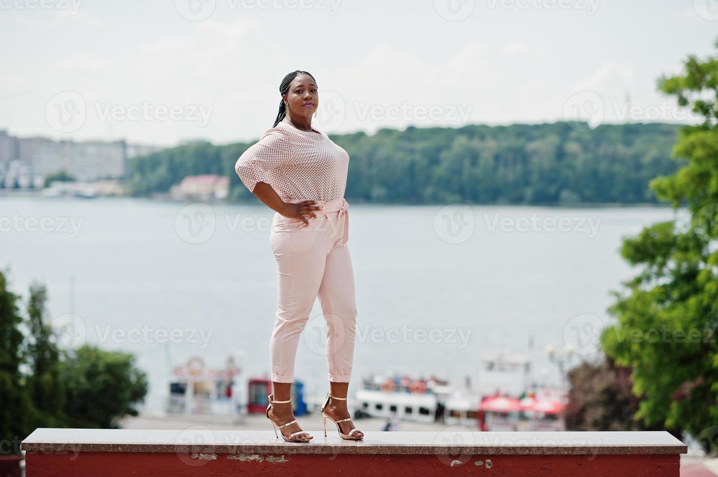 African girl posed at street of city wear on peach blouse and pants. photo