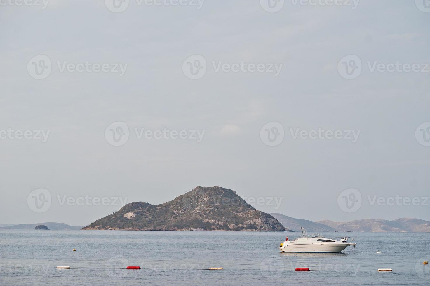 Yacht on beautiful tropical sea bay. Scenic landscape with mountain islands and blue lagoon on Aegean sea. Exotic scenery. Popular landmark, famous destination of Bodrum, Turkey. photo