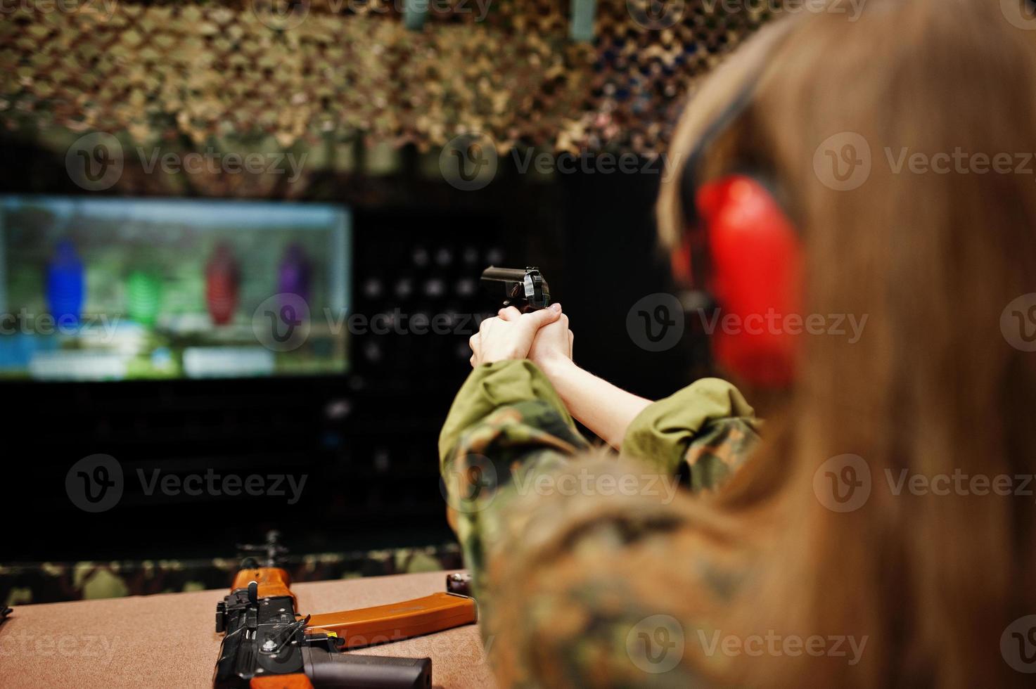Shooting at the shooting range.The woman at the shooting range shot from gun. photo