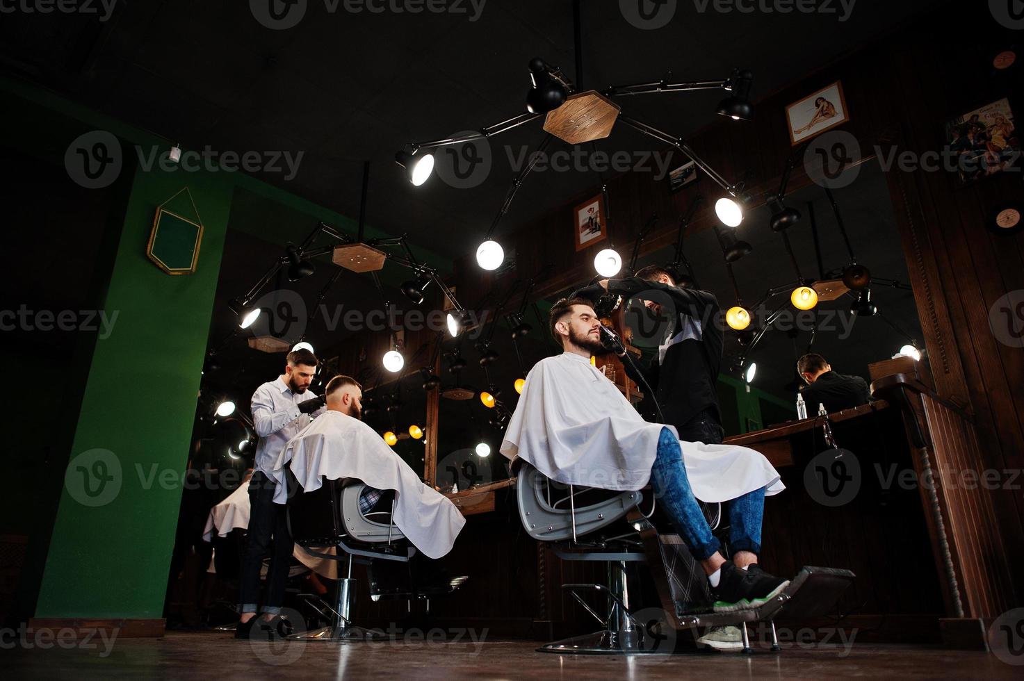 Handsome bearded man at the barbershop, barber at work. photo