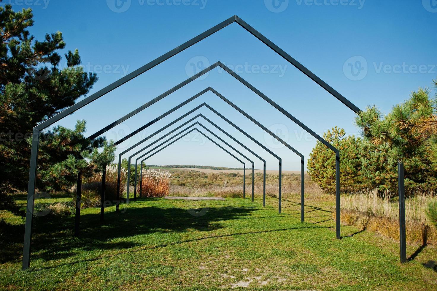 Triangular metal arch outdoor for wedding ceremonies. photo