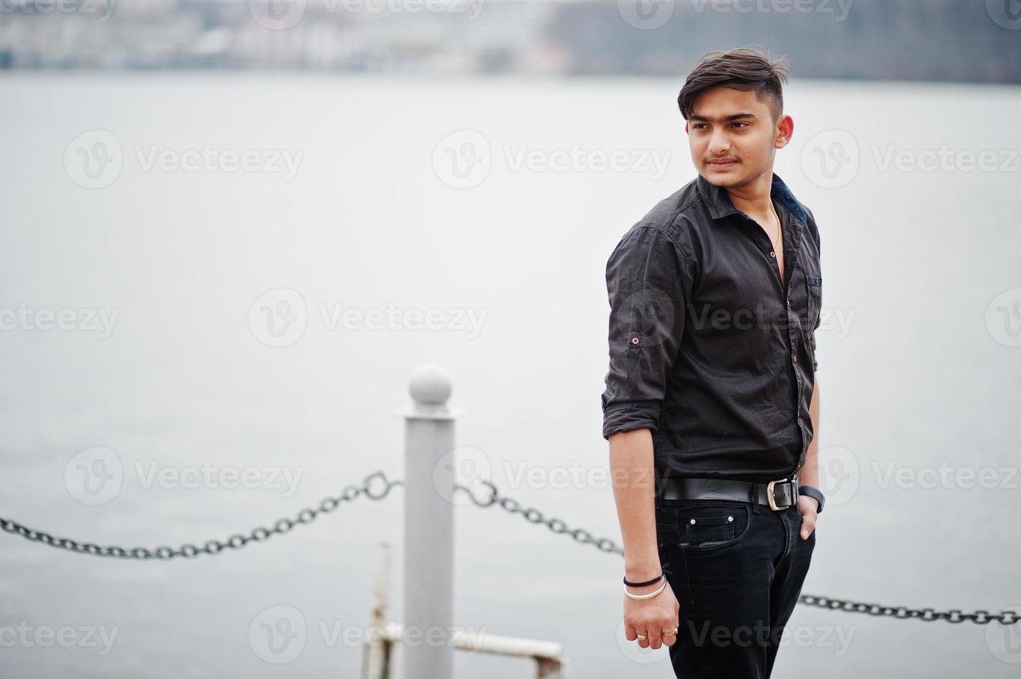 Indian man in brown shirt posed outdoor. photo