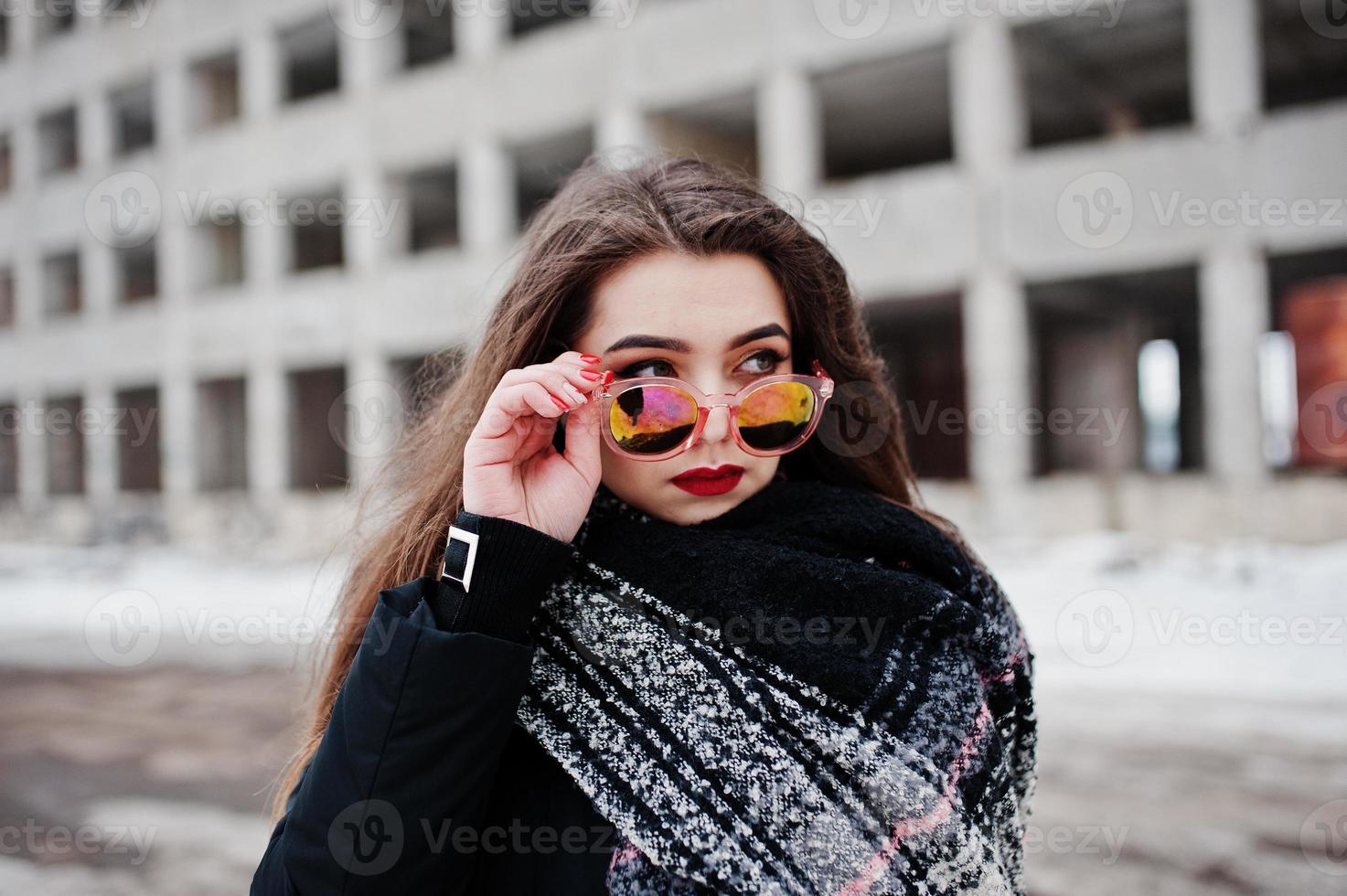 Brunette stylish casual girl in scarf and sunglasses against abandoned factory place. photo