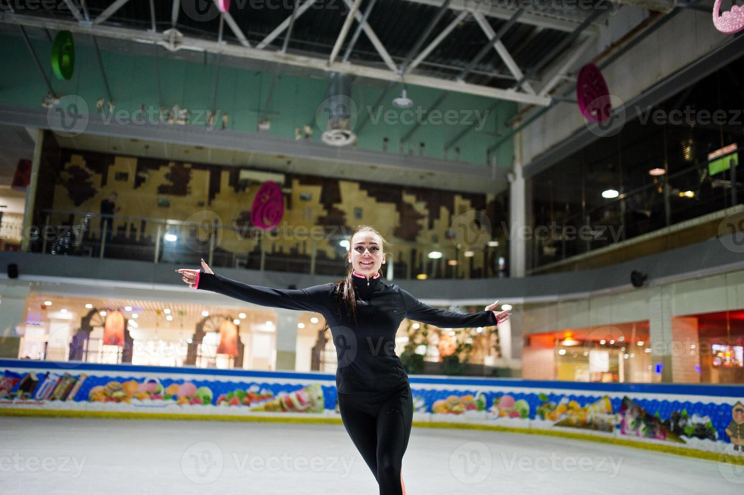 Figure skater woman at ice skating rink. photo