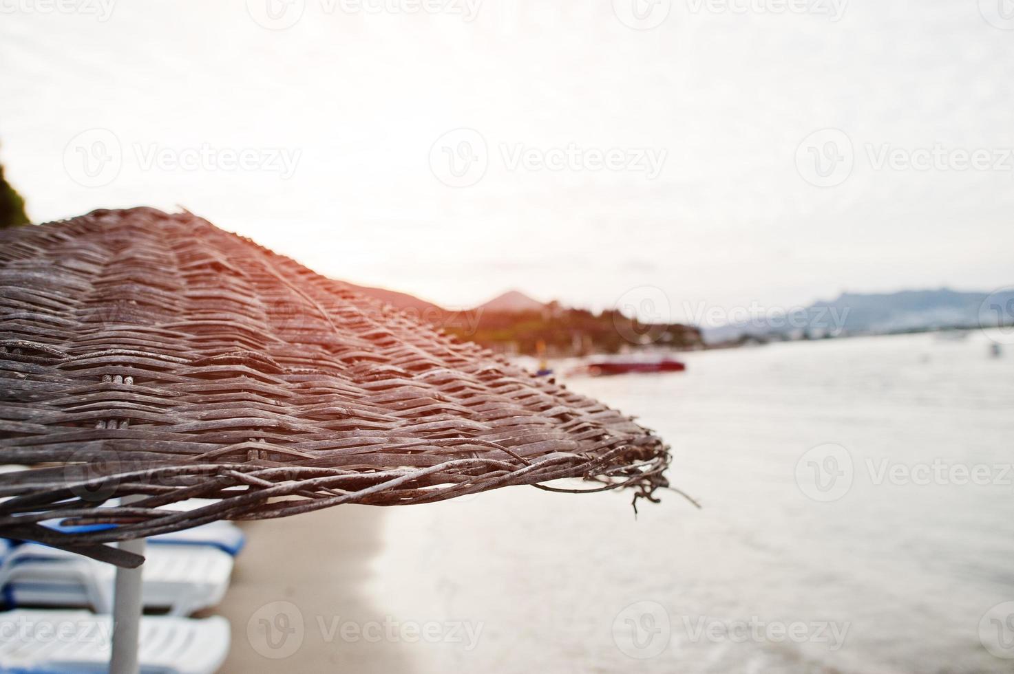 Bamboo and reed straw beach umbrellas photo