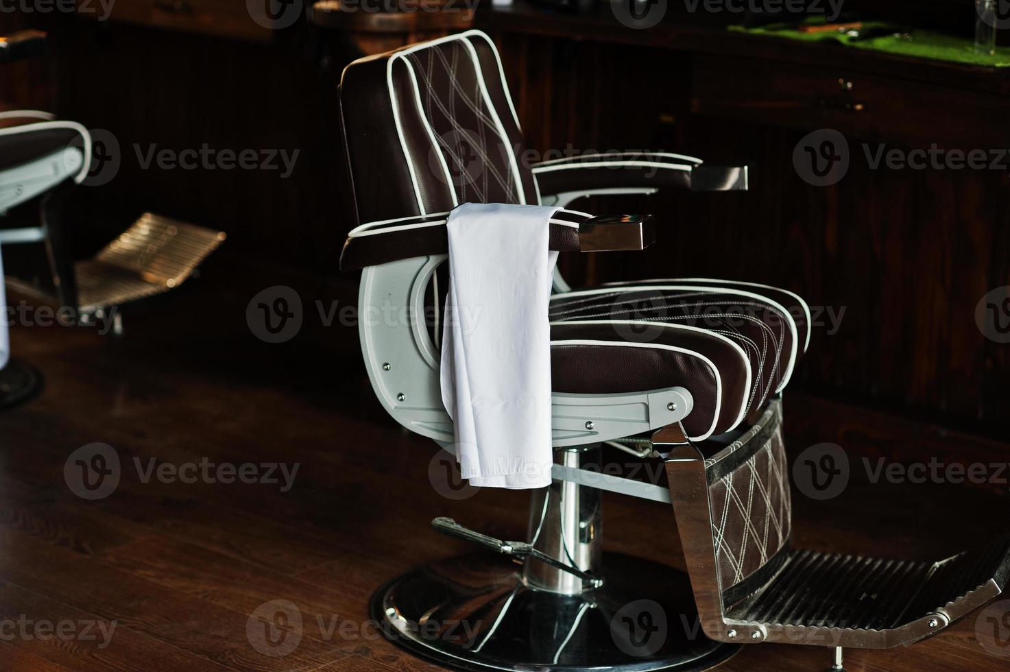 Brown vintage leather chair at stylish barber shop. photo