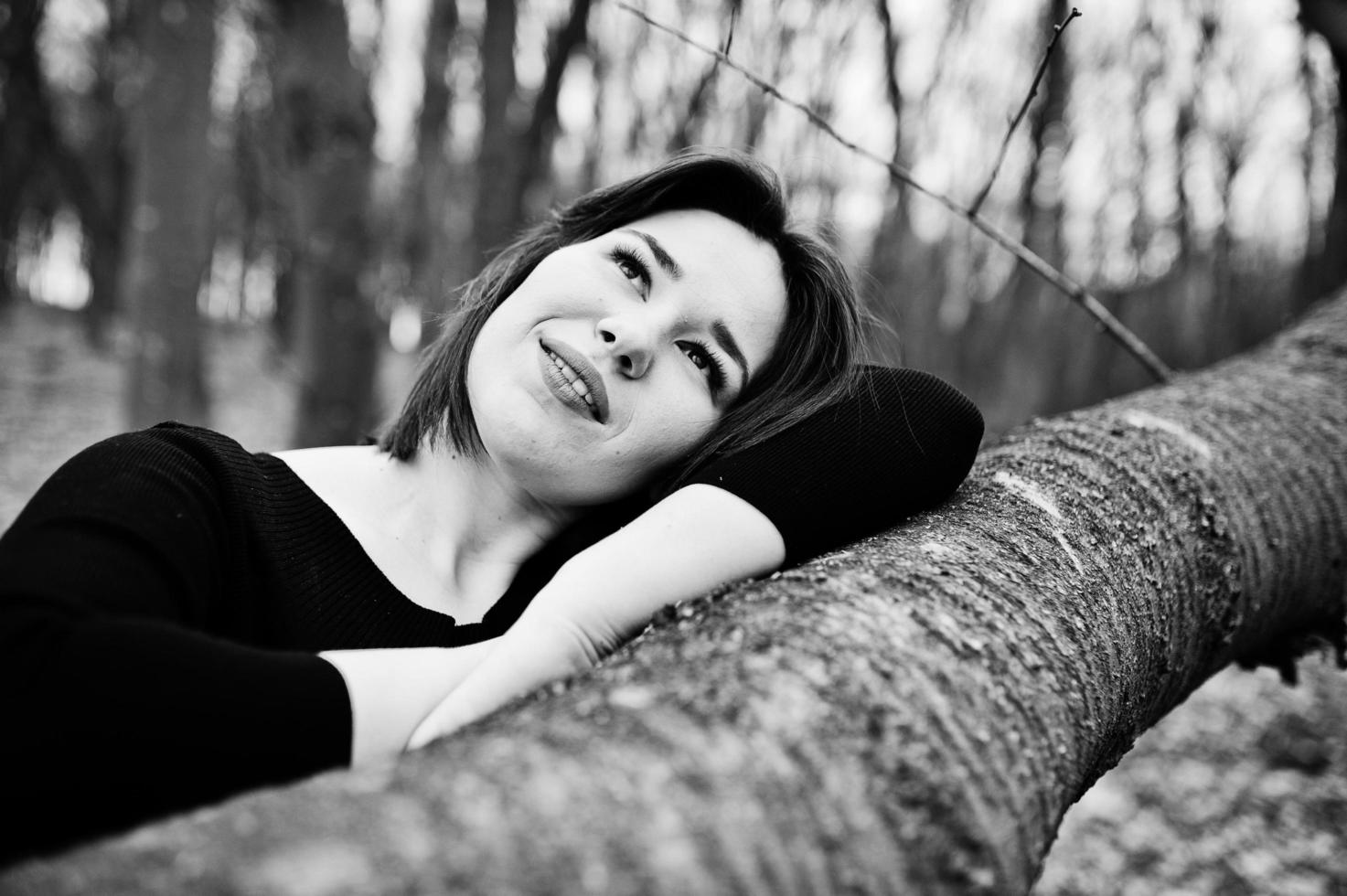 Portrait of brunette girl in black dress at spring wood. photo