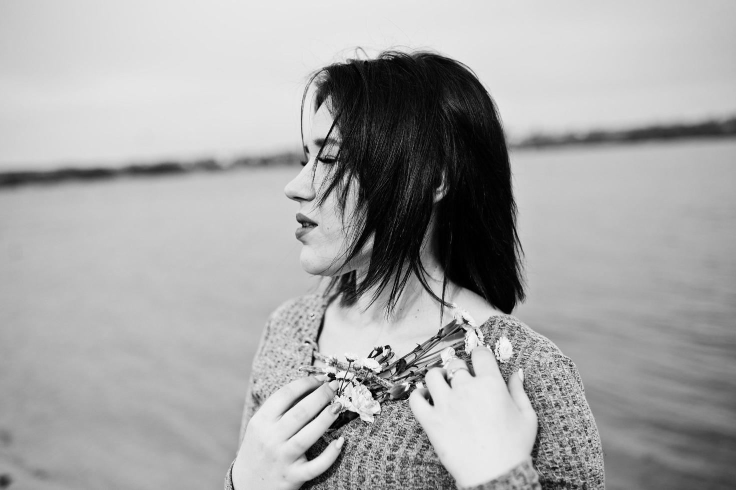 Portrait of brunette girl in gray dress background the lake. photo