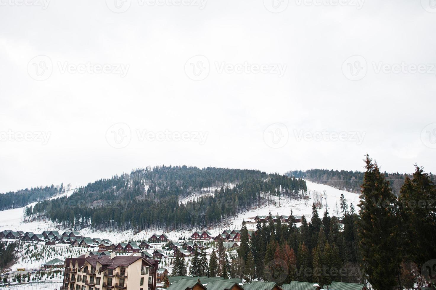 Scenic winter view of ski resort with house and cottage in Bukovel, Carpathian Mountains, Ukraine. photo