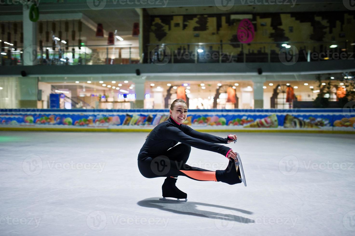 Figure skater woman at ice skating rink. photo