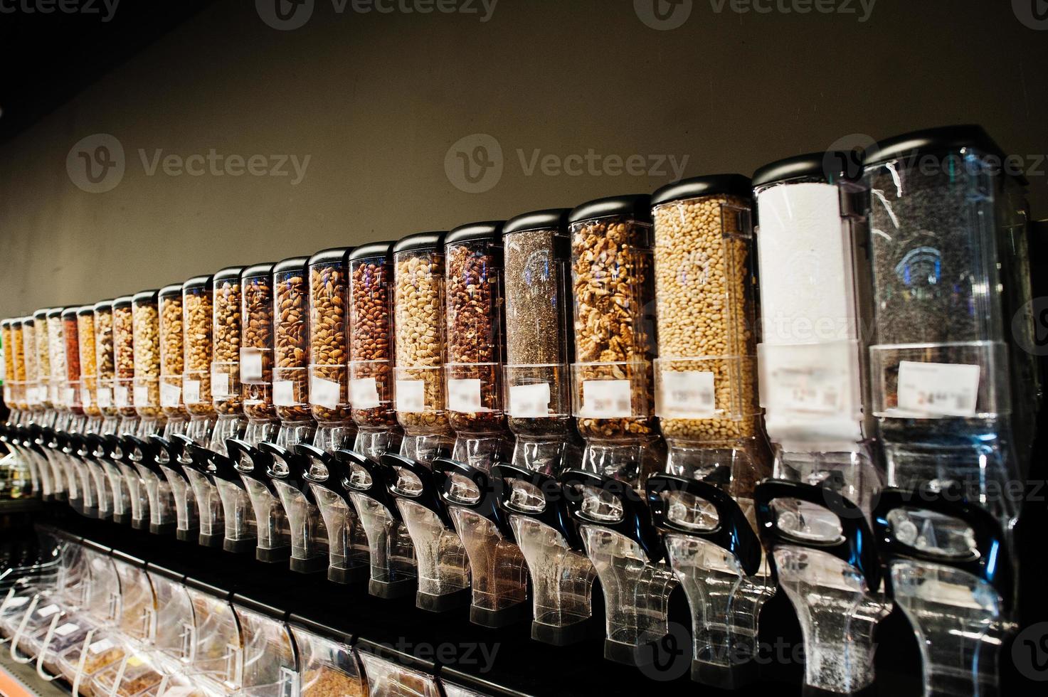 Row of different nuts at supermarket. photo