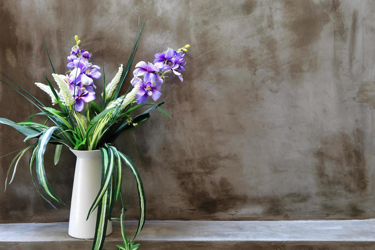 Bouquet of peonies in a vase against  wall. Interior photo