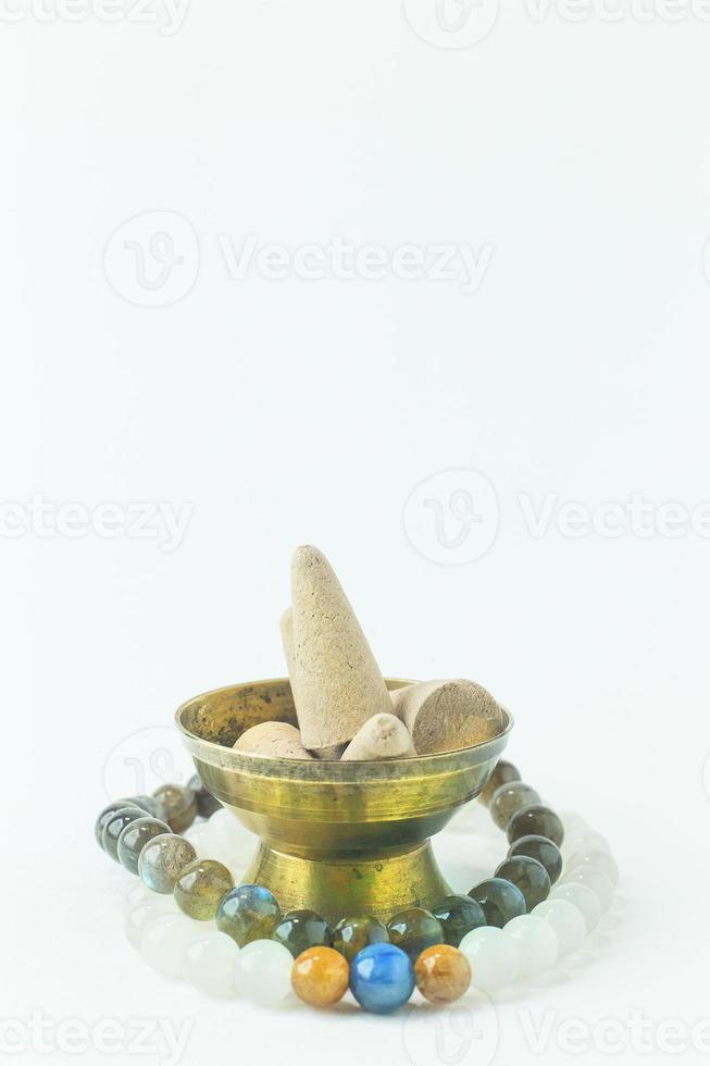 Incense Cone in a stand with the feather for background. photo