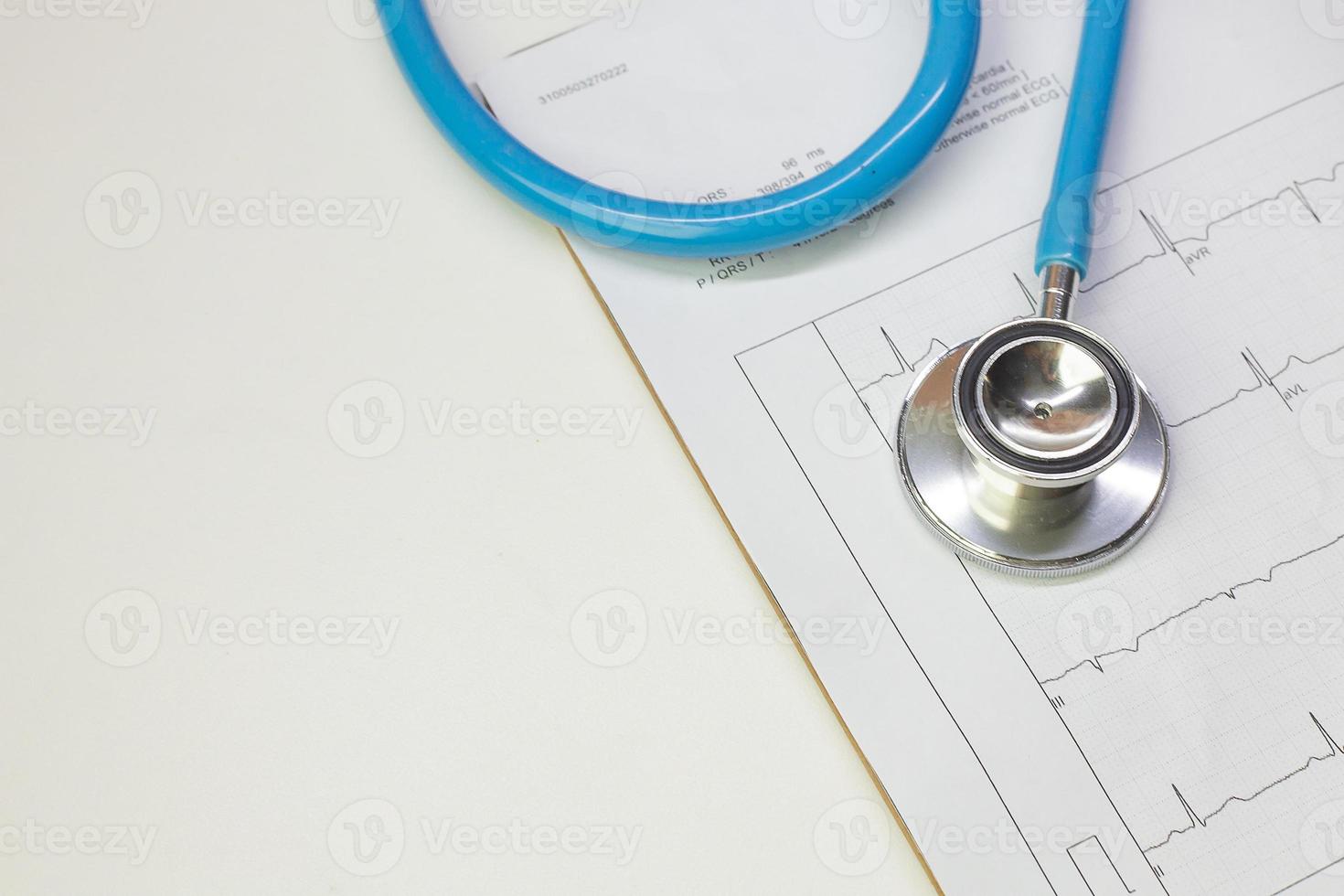 Blue stethoscopes and  Electrocardiography  chart close up image. photo