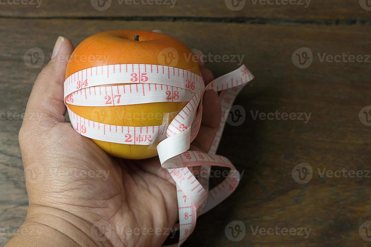 Apple and measuring tape image  for diet content. photo