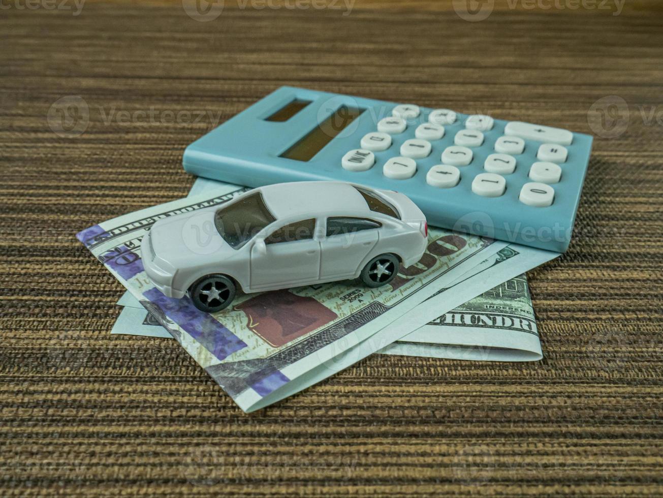 car and calculator on wood table for business content. photo