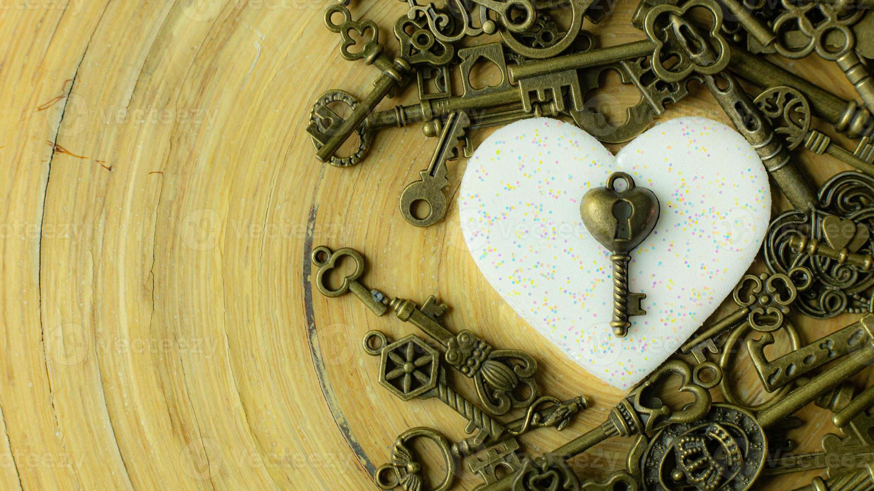 white heart and gold key  for valentines day content. photo