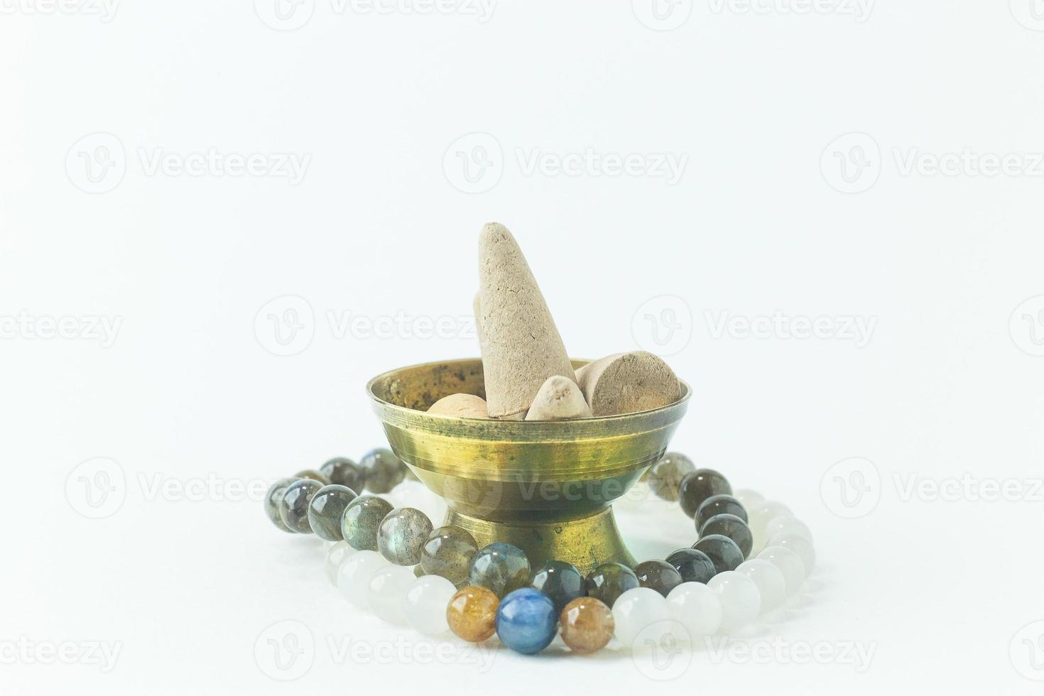 Incense Cone in a stand with the feather for background. photo