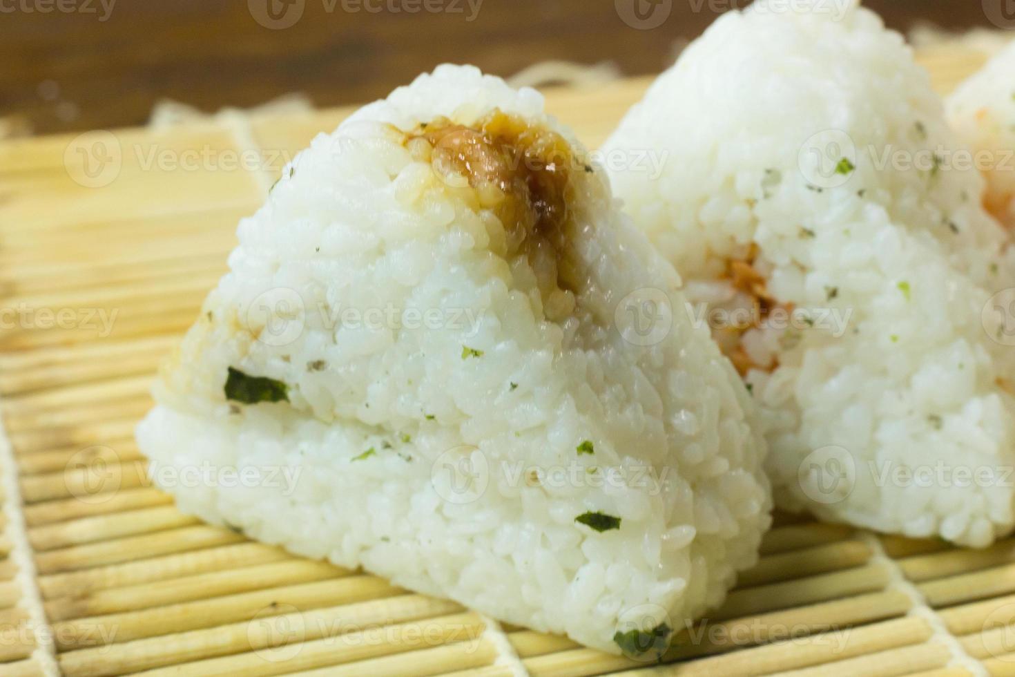 The Japanese food Onigiri  white rice formed into triangular or cylindrical shapes and often wrapped in nori. photo