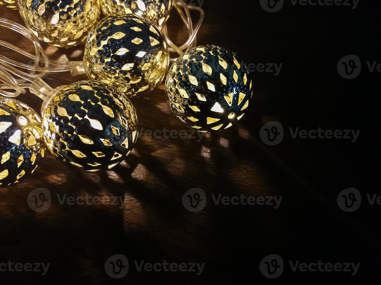 Christmas lights ball decor on wood table. photo