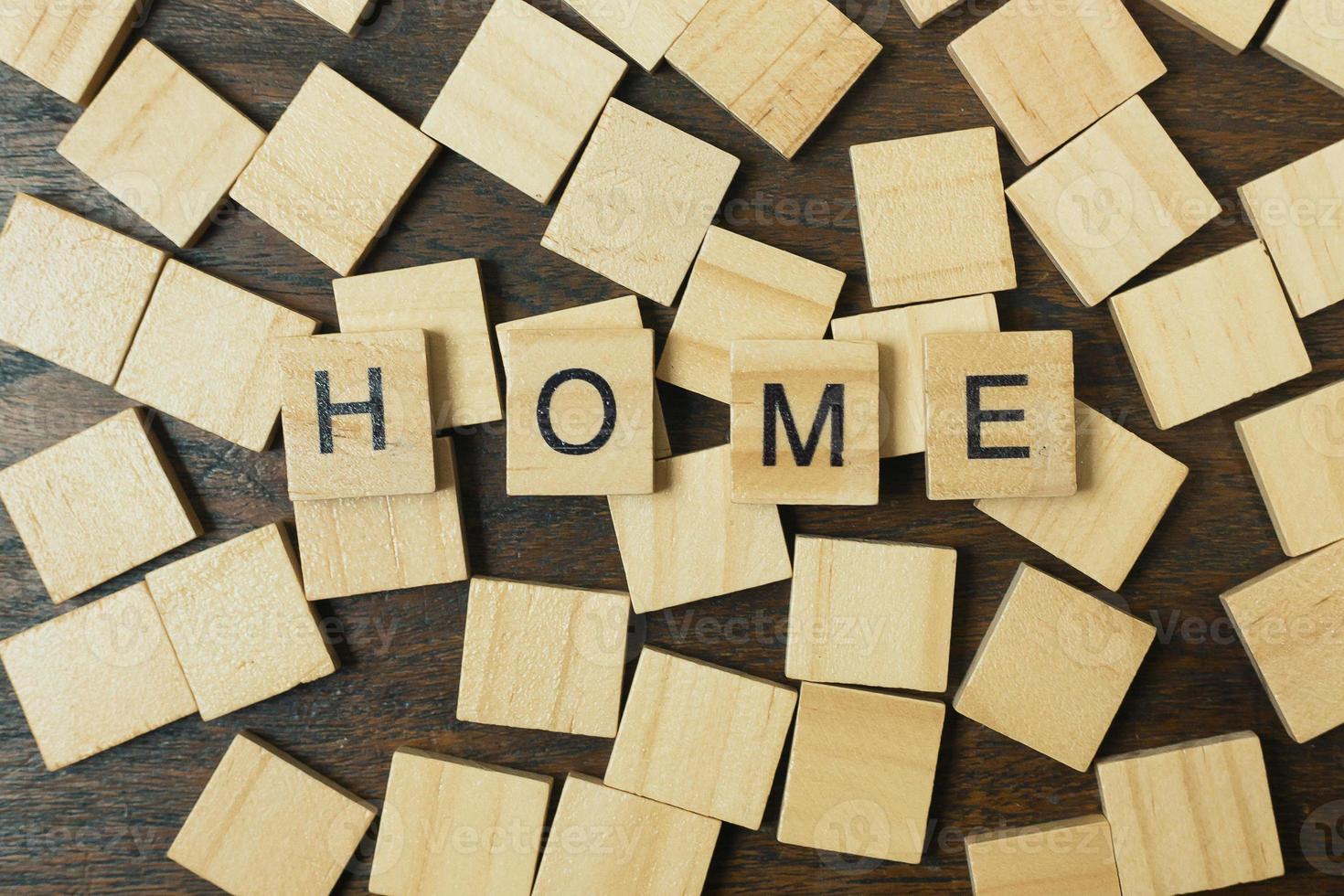 Home word on wood plate abstract background. photo