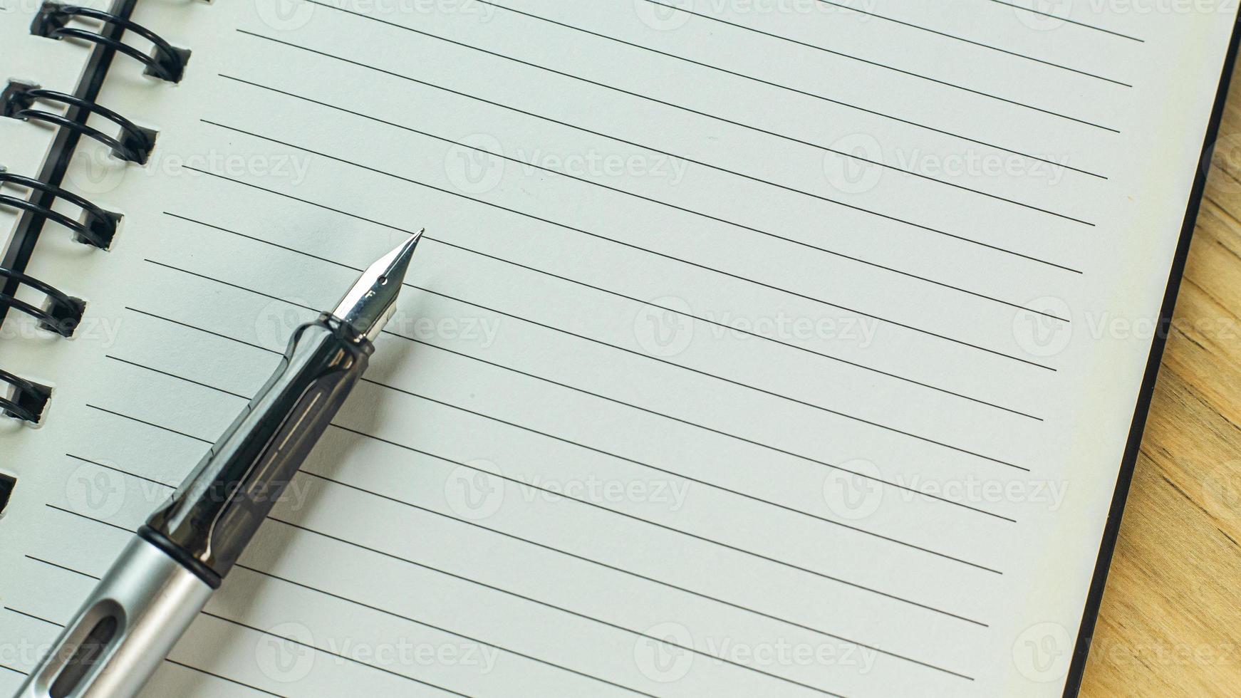silver pen on wood table for business  content. photo