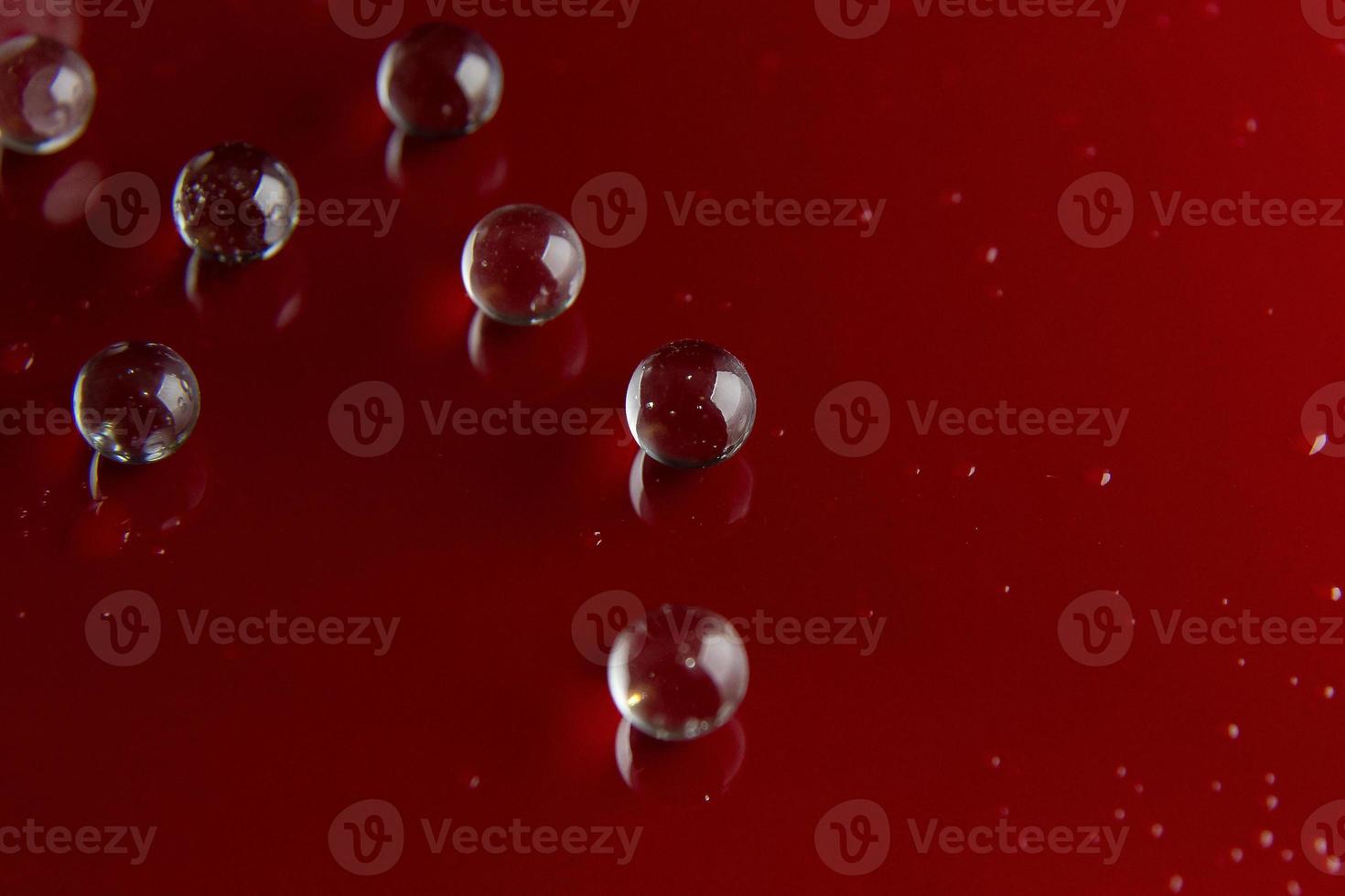 The abstract  crystal ball on red glossy floor background. photo