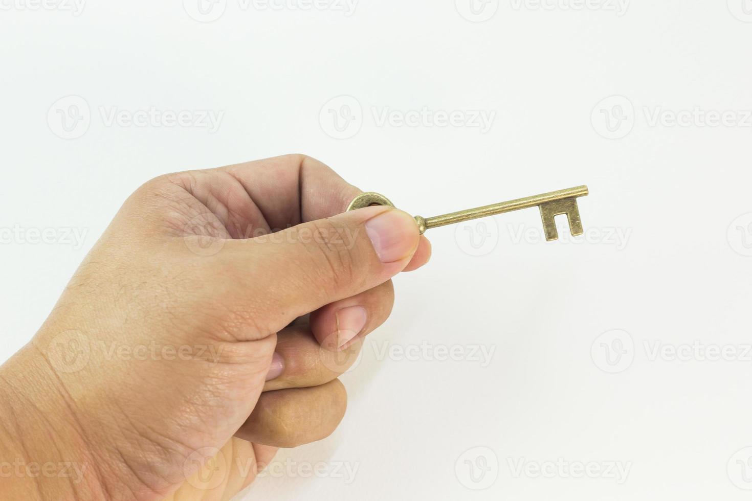 vintage gold key in hand close up image. photo